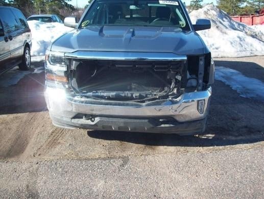 Damaged Chevrolet Silverado missing front grille and headlights