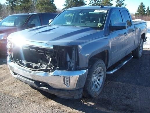 Damaged Chevrolet Silverado with missing front grille and headlights